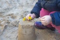 Baby girl makes cakes out of sand, plays in the sandbox on the playground Royalty Free Stock Photo
