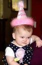 Baby girl making a funny face at her first birthday party Royalty Free Stock Photo