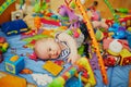 Baby girl with many colorful toys Royalty Free Stock Photo