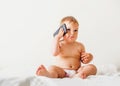 Baby girl with mobile phone near her ear, calling someone, copy space, gen z development Royalty Free Stock Photo