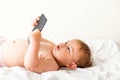 Baby girl with mobile phone near her ear, calling someone, copy space, gen z development Royalty Free Stock Photo