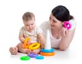 Baby girl and mother playing together with toy