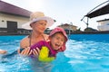 Baby girl with mother in swimming pool learn to swim. Royalty Free Stock Photo