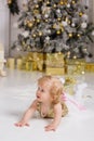 Baby girl near luxury decorated christmas tree Royalty Free Stock Photo