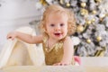 Baby girl near luxury decorated christmas tree Royalty Free Stock Photo