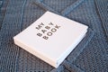 Baby girl newborn book album on blue knitting plaid background