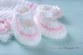 Baby girl nursery pink and white stripe wool booties close up