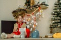 Baby girl opening Christmas presents. candy and gifts in advent calendar on winter morning Royalty Free Stock Photo