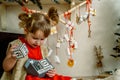 Baby girl opening Christmas presents. candy and gifts in advent calendar on winter morning Royalty Free Stock Photo