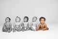 Baby girl with other babies looking away on floor Royalty Free Stock Photo