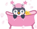 Baby girl penguin taking a bath with shower duck Royalty Free Stock Photo