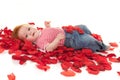 Baby girl on petals roses