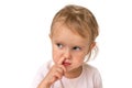 Baby girl is picking her nose with finger inside Royalty Free Stock Photo