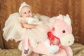 Baby girl on a pink poney Royalty Free Stock Photo