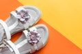 leather white baby girl summer sandals with flower decoration.Baby girl shoes on colorful background. kids fashion pair Royalty Free Stock Photo