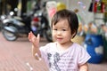 Baby girl play soap bubble