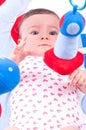Baby girl playing with baby toys gym. Royalty Free Stock Photo
