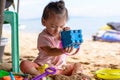 Baby girl playing with beach toys on the beach Royalty Free Stock Photo