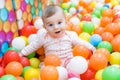 Baby girl playing with colorful balls Royalty Free Stock Photo