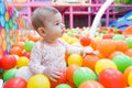 Baby girl playing with colorful balls Royalty Free Stock Photo