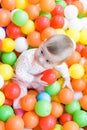 Baby girl playing with colorful balls Royalty Free Stock Photo