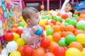 Baby girl playing with colorful balls Royalty Free Stock Photo