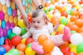Baby girl playing with colorful balls Royalty Free Stock Photo