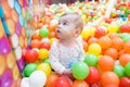 Baby girl playing with colorful balls Royalty Free Stock Photo