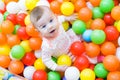 Baby girl playing with colorful balls Royalty Free Stock Photo