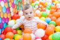 Baby girl playing with colorful balls Royalty Free Stock Photo