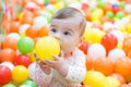 Baby girl playing with colorful balls Royalty Free Stock Photo