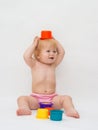 Baby girl playing colorful caps Royalty Free Stock Photo