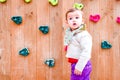 Baby girl playing next to a climbing wall Royalty Free Stock Photo