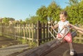 Baby girl playing over a seesaw swing on the park Royalty Free Stock Photo