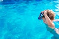 Baby girl playing in the pool with a plastic toy in summer in the sun with copy space Royalty Free Stock Photo
