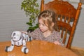 Baby girl playing robot dog video without processing