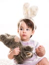 Baby girl playing with toy rabbit Royalty Free Stock Photo