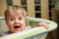 Baby girl in playpen