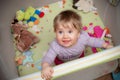 Baby girl in playpen Royalty Free Stock Photo