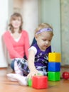 Baby girl plays with blocks Royalty Free Stock Photo