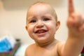 Baby girl pointing his finger straight to the camera. Cute adorable baby after bath time Royalty Free Stock Photo