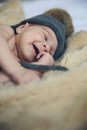 Baby girl with pompom hat sleeping and laughing Royalty Free Stock Photo