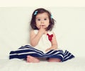 Baby girl portrait, sit on white towel Royalty Free Stock Photo