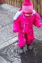 Baby girl puddle pink winter clothes boots female Royalty Free Stock Photo