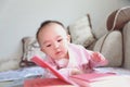 Baby girl reading book Lie down on sofa