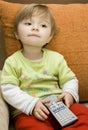 Baby girl with remote control Royalty Free Stock Photo