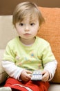 Baby girl with remote control Royalty Free Stock Photo