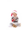 Baby girl in Santa`s hat with christmas ornament Royalty Free Stock Photo