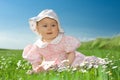 Baby girl sat in flowery field