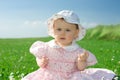 Baby girl sat in flowery field